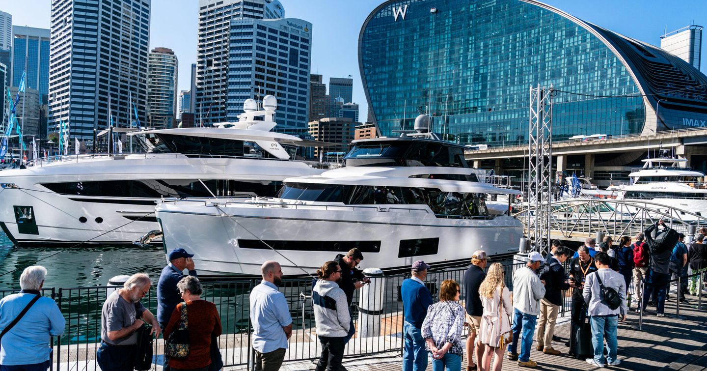 People queuing next to superyachts at Sydney International On-Water Boat Show