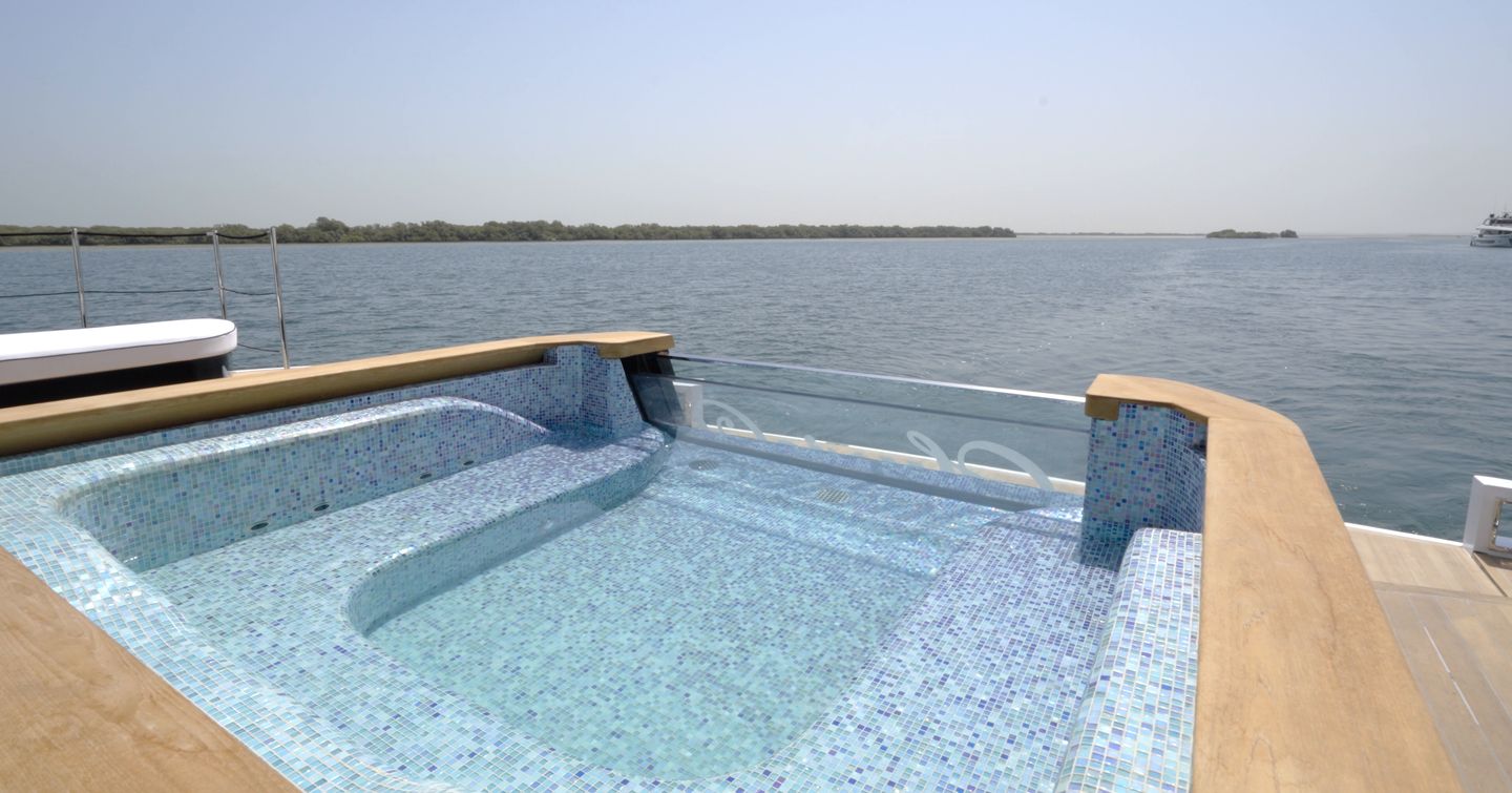 Glass-fronted infinity pool at the stern of the Gulf Craft Majesty 145 overlooking the water
