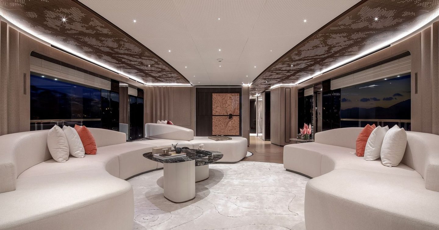 Sirena 42M superyacht main salon with curved white sofa 