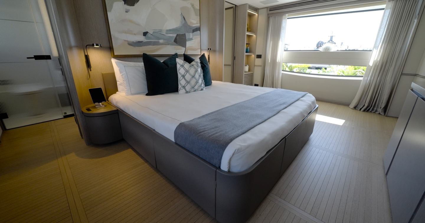 Benetti Oasis 34M owner's suite featuring hull-side glazing, king-size bed and contemporary interior by Bonetti/Kozerski Architecture.