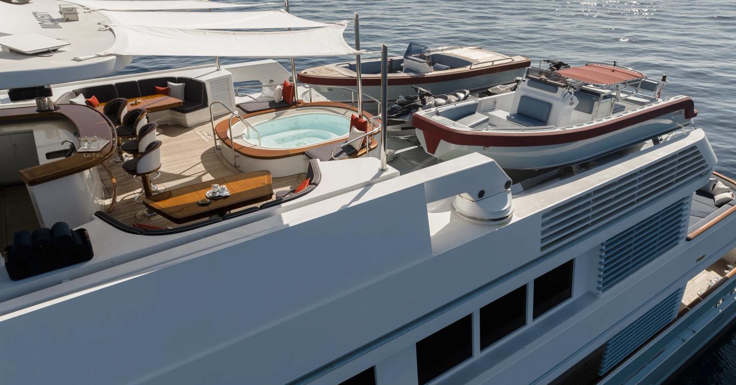 Superyacht Olympus upper aft deck with jacuzzi and tenders stowed 