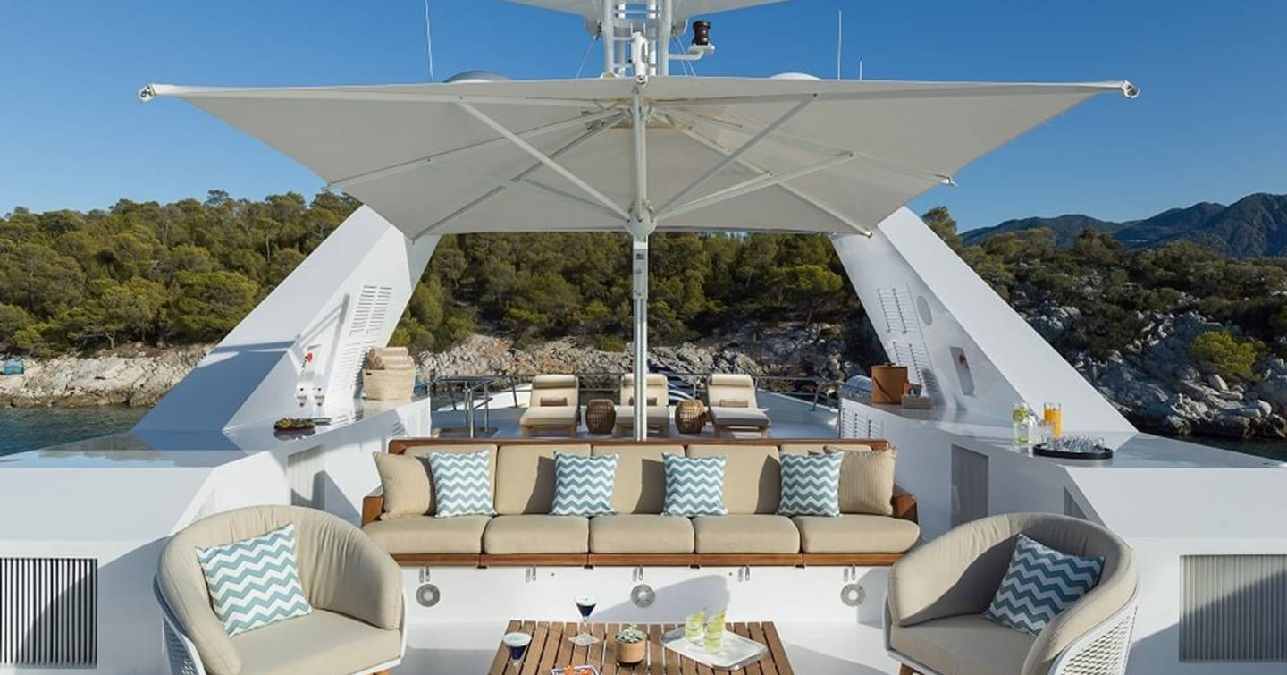 Feadship Superyacht Kassandra's sundeck with shaded seating  and sunpads 
