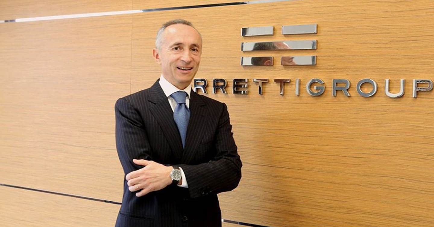Alberto Galassi standing in front of Ferretti Group sign