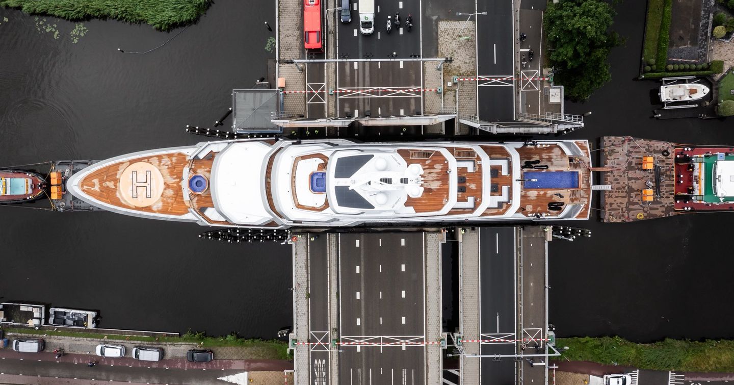 Aerial view of Feadship 80m Explorer Yacht Valor making her way through dutch canals 