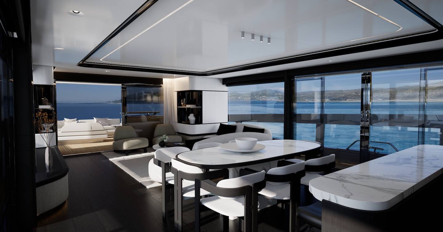 Main saloon of Pearl 100 Hybrid motor yacht with dining table, lounge seating, and ocean views through sliding glass doors.