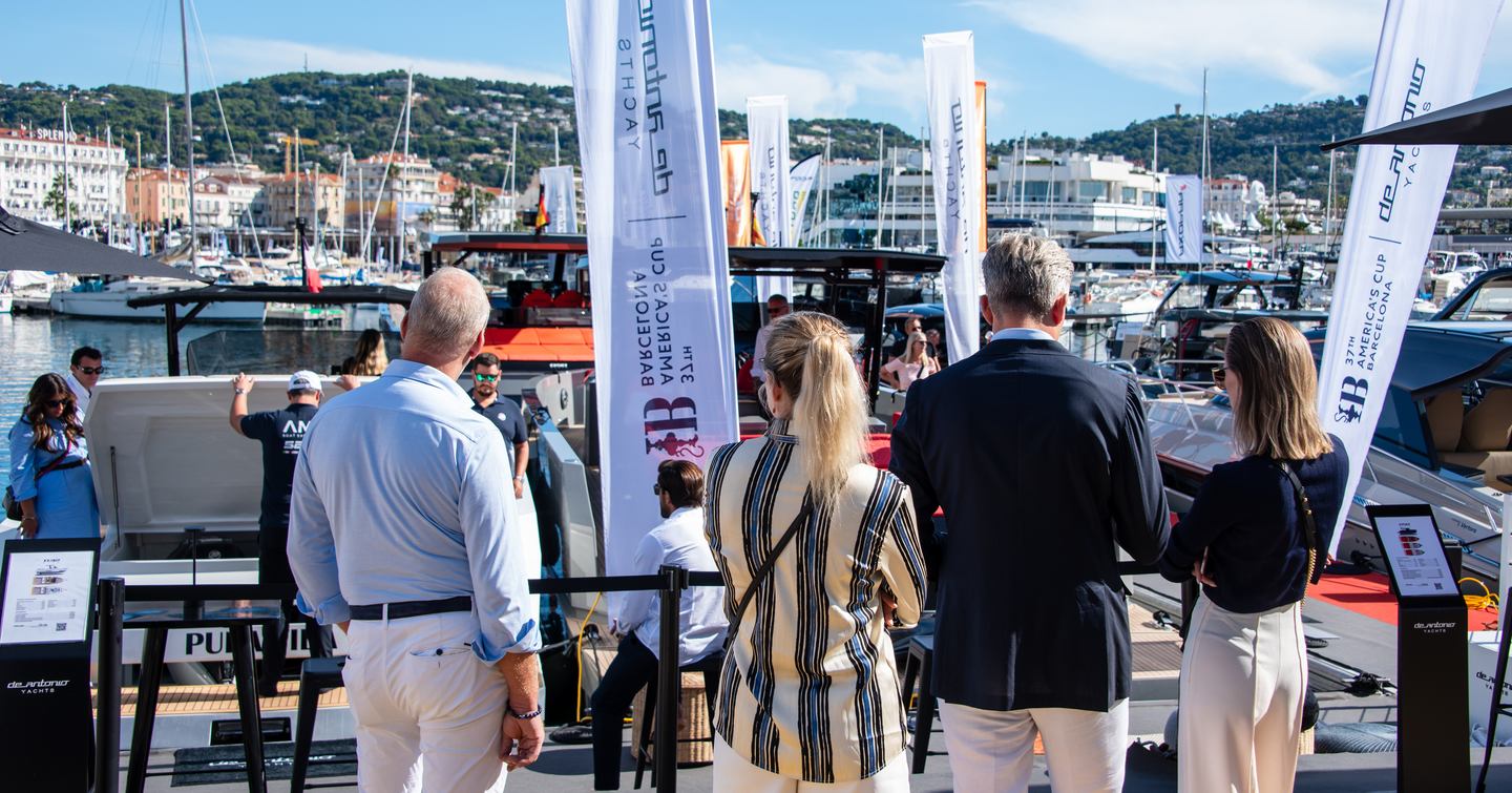 Visitors at the Cannes Yachting Festival looking at boats in the marina