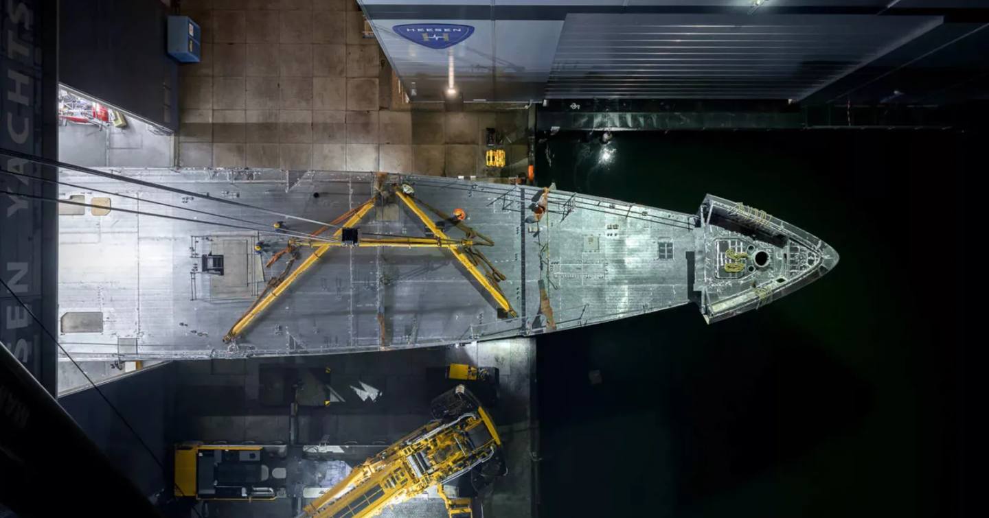 Aerial view of superyacht Project Evita hull leaving shipyard 