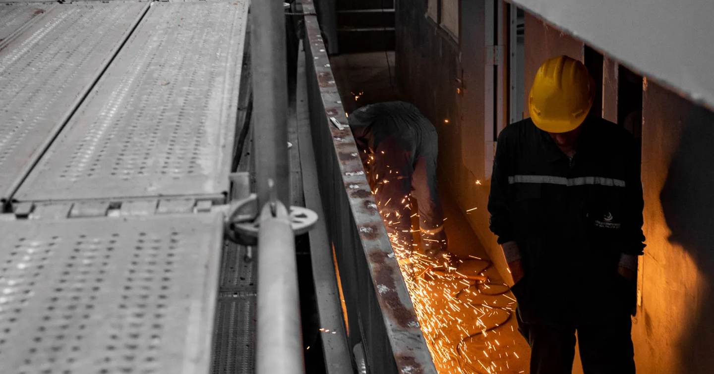 superyacht next to welding work on superyacht 