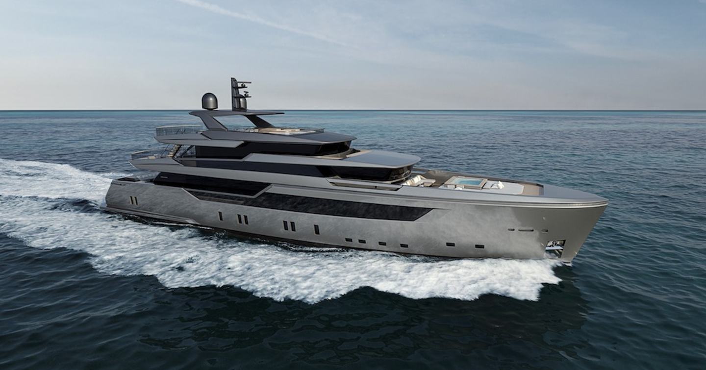 The superyacht KAMAKASA running through a flat blue sea showcasing her powerful grey exterior