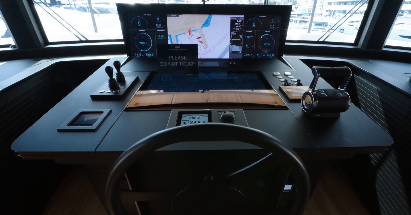 Custom Line Navetta 38 helm console with multi-screen navigation display, wheel and engine controls
