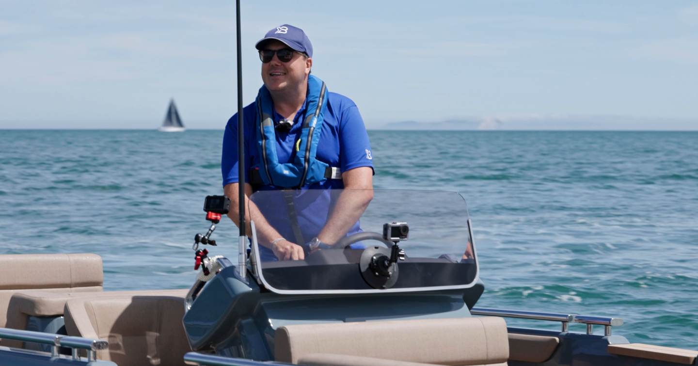 Driver standing at the helm of the Evene Origin 71 at low speed