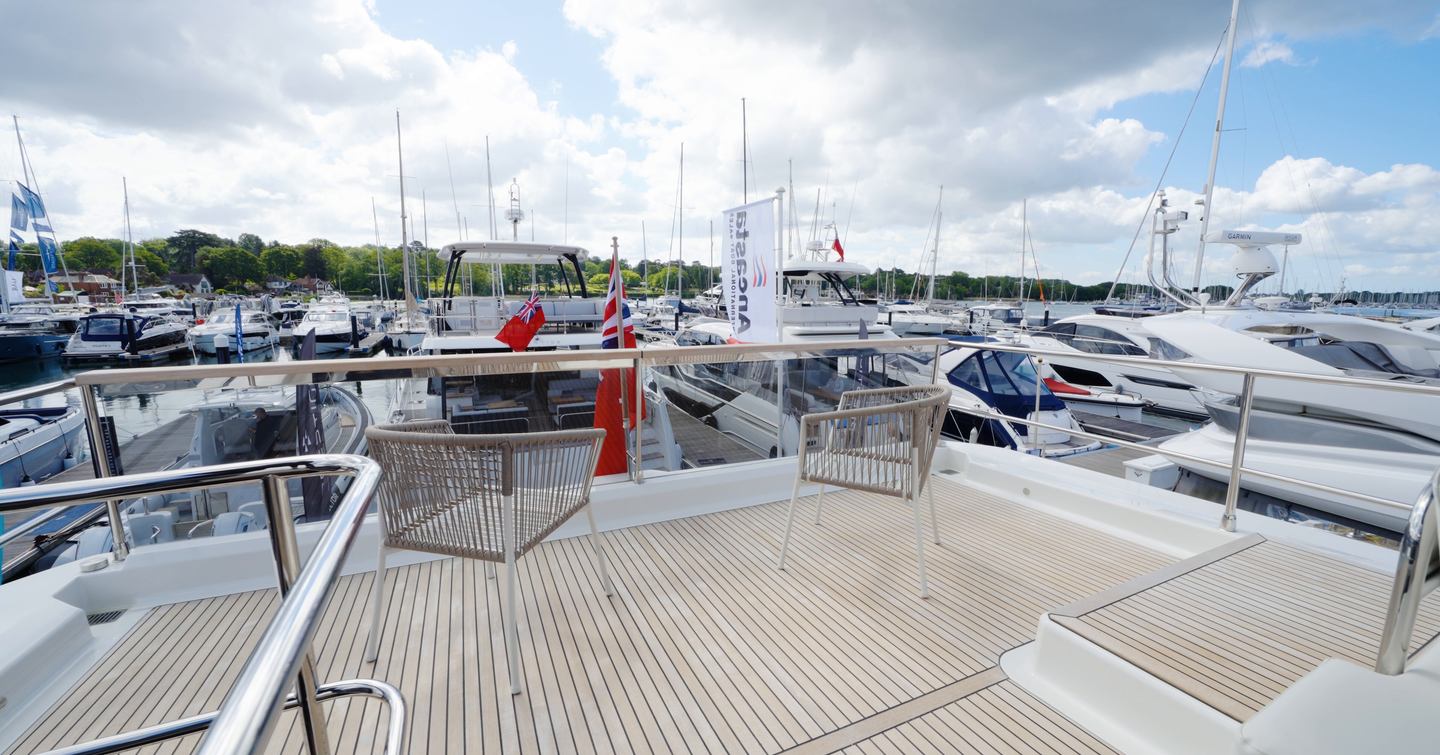 Beneteau Grand Trawler 63 flybridge aft terrace with open seating and panoramic marina views