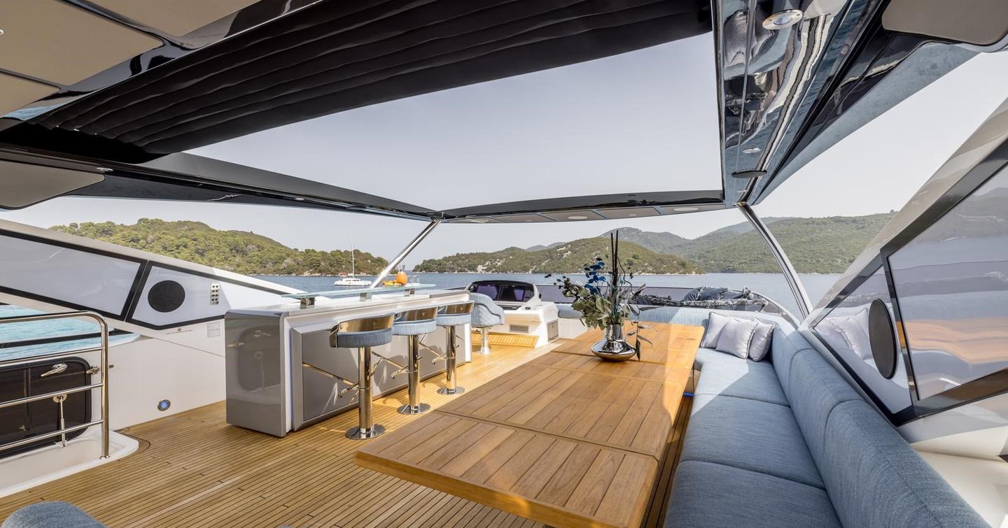 Motor yacht Exit's upper deck with seating and bar area