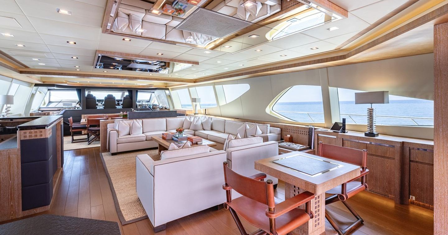 Superyacht Royale X main saloon with L-shaped white sofa