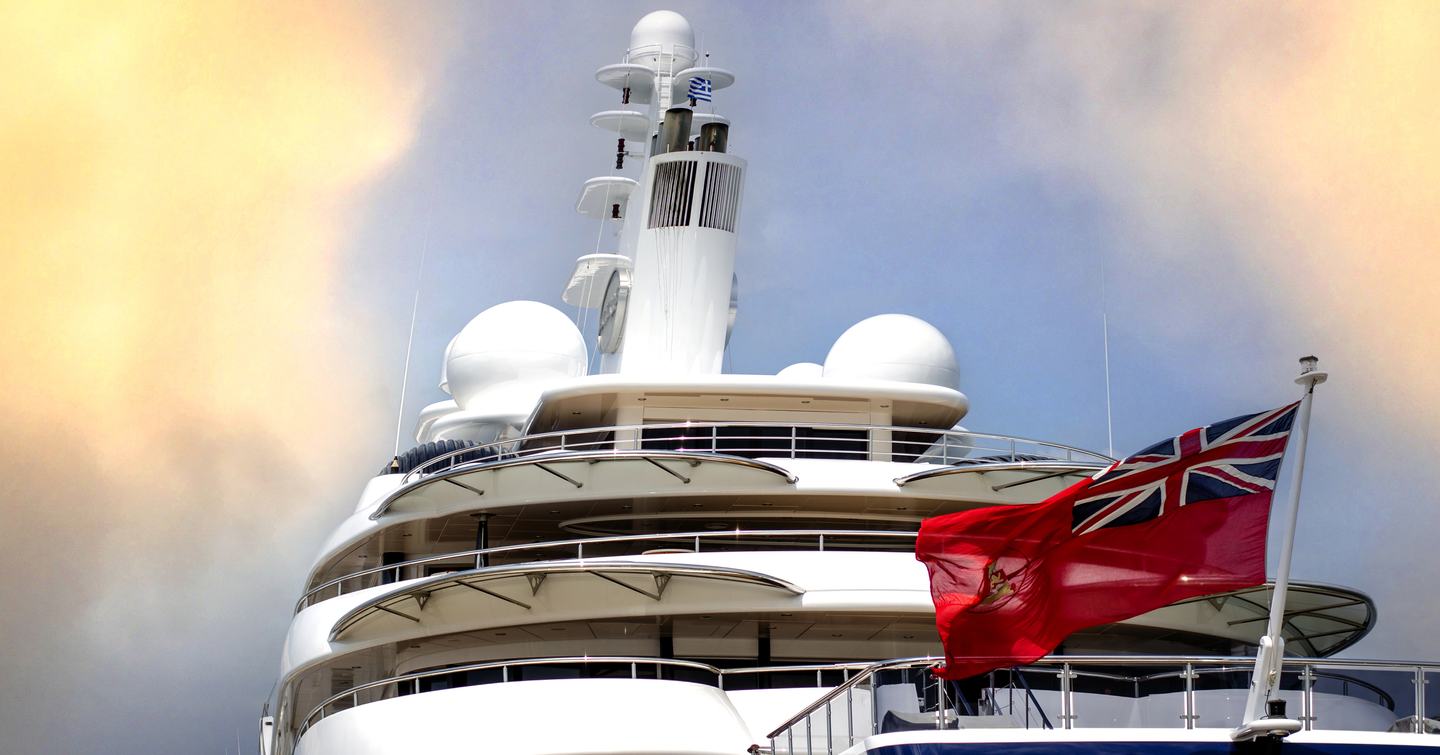 red ensign on stern of blue hull superyacht