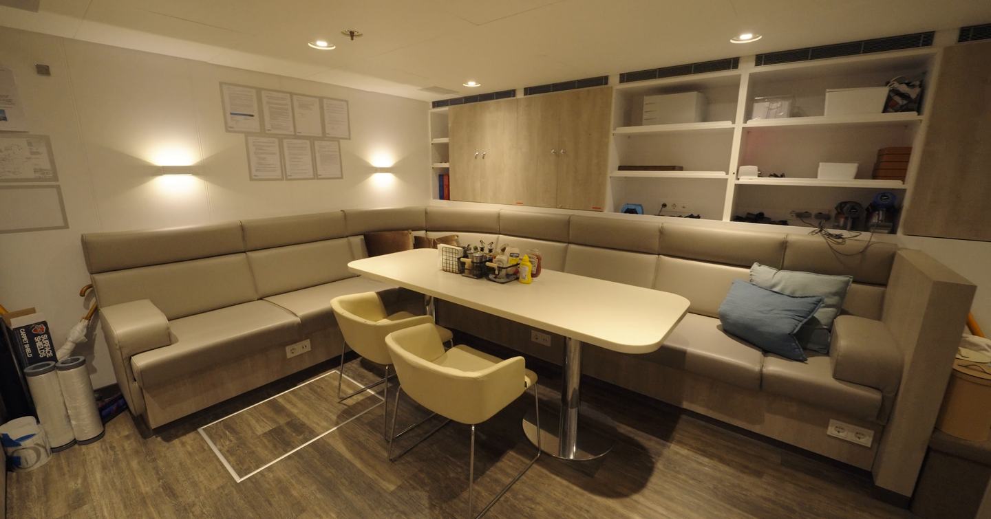 Crew mess dining and lounge area on the Amels 242 Casino Royale with seating and storage for the yacht’s crew.