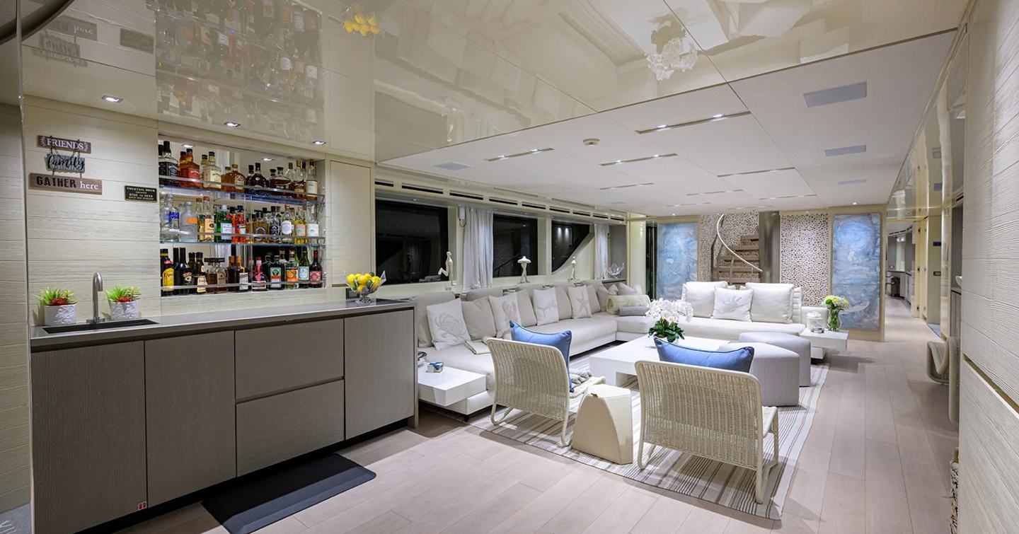 Main saloon on board motor yacht Phoenix with bar and L shaped sofa 