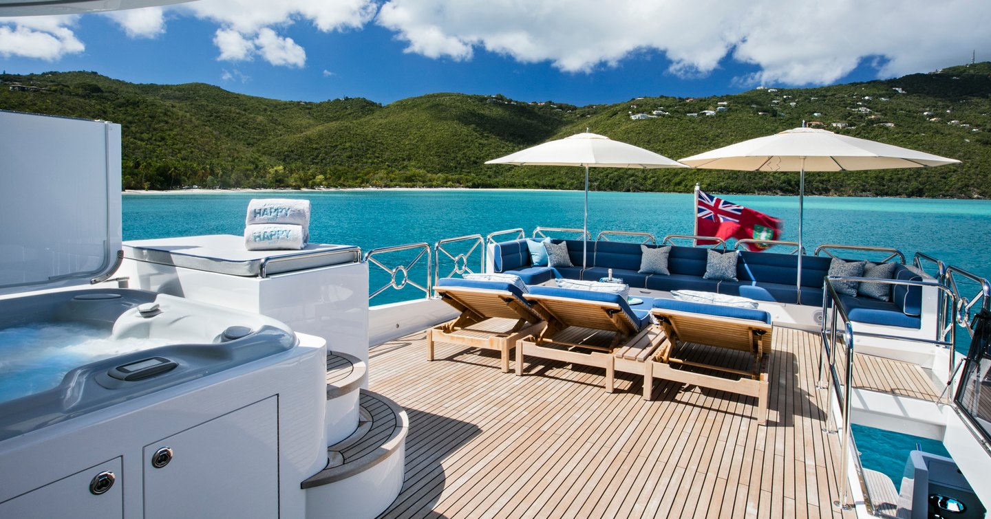 The exterior lounge of a Johnson 110 Skylounge yacht