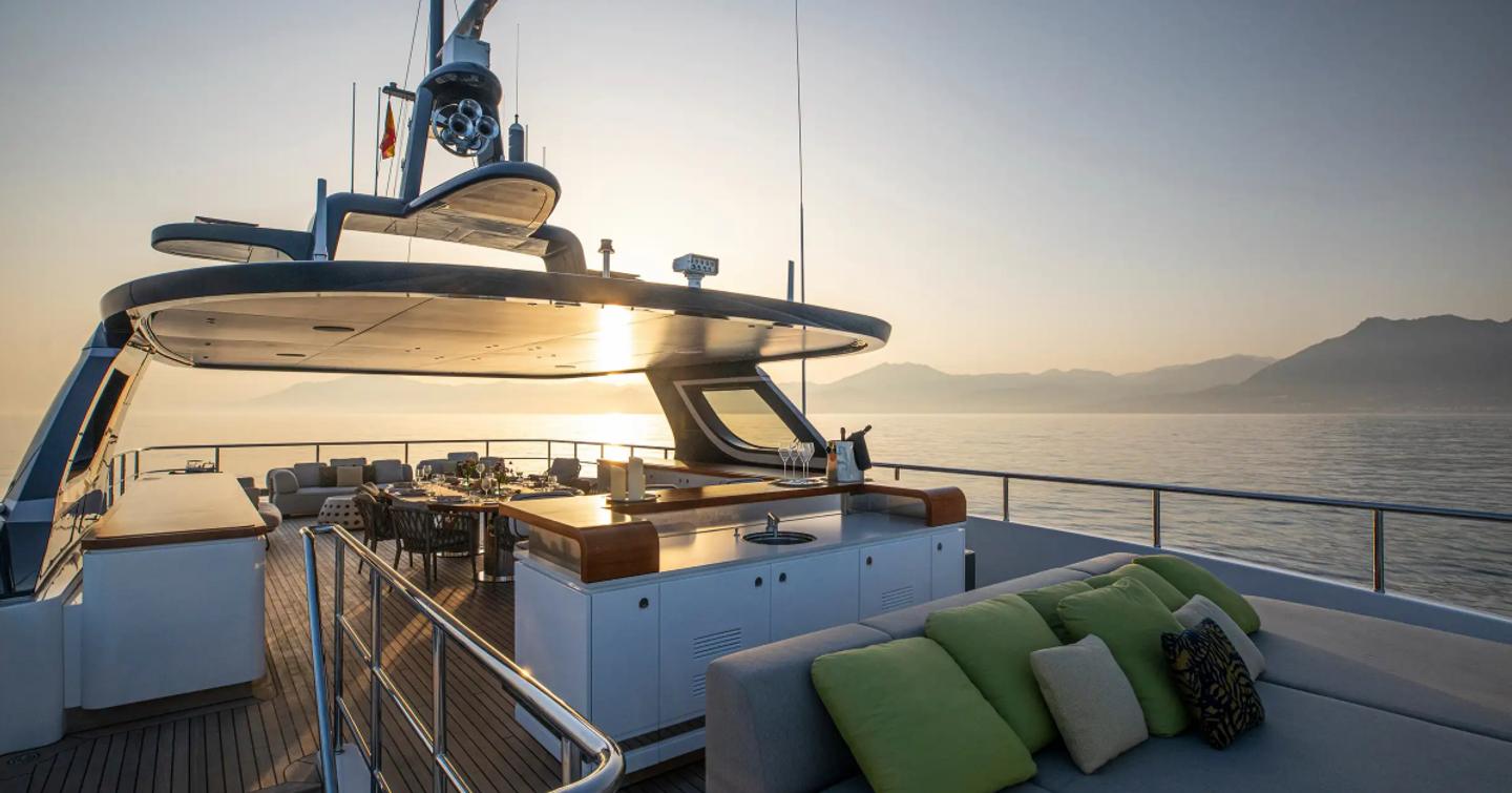 Superyacht Tosun sundeck with sunpads, alfresco dining and bar area