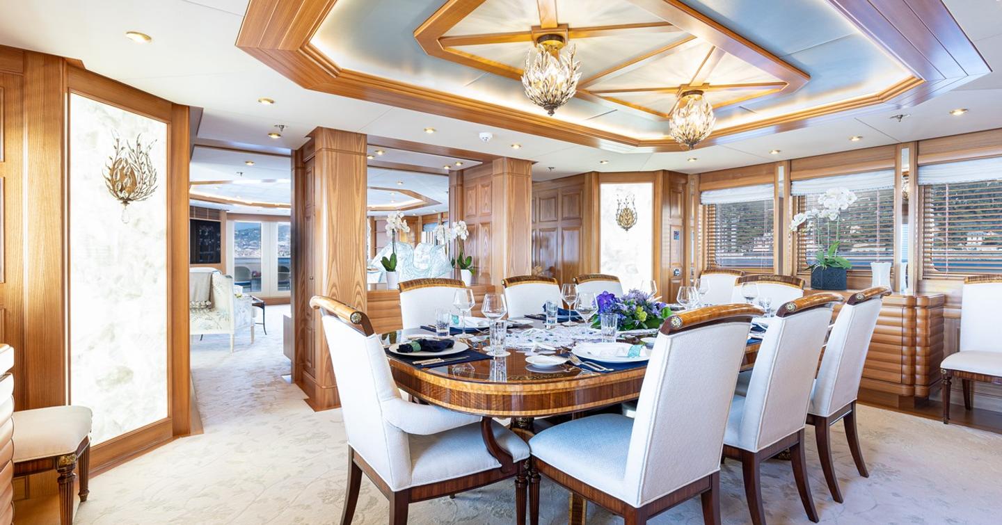 Dining area on motor yacht vibrance with table set for eight and panoramic views