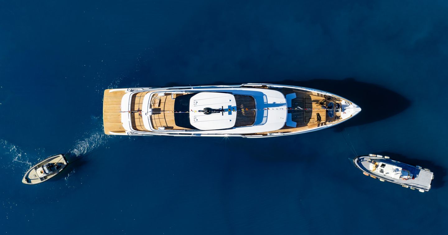 Aerial view of Fifth Custom Line Navetta 38 motor yacht at anchor next to tenders