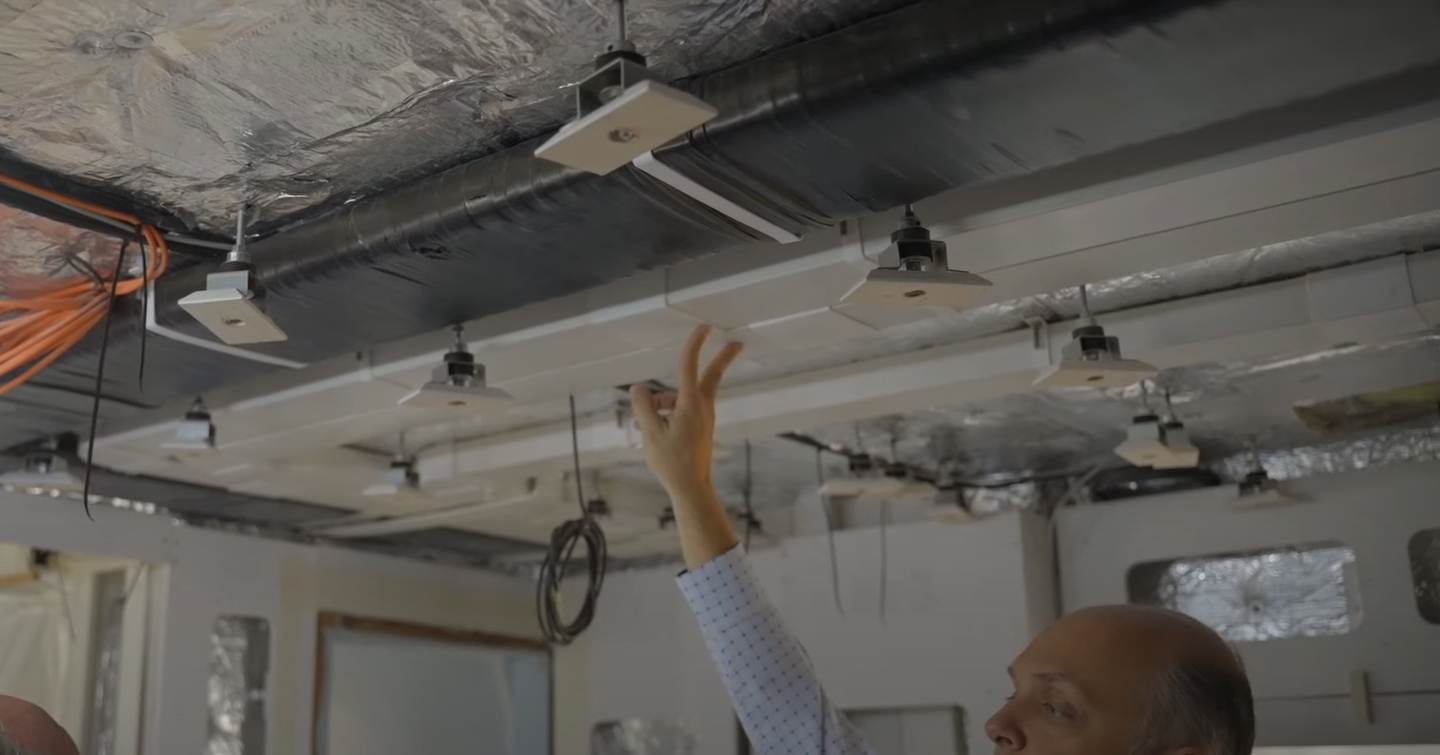 Man pointing to ceiling construction work on the First Lazzara UHV100 motor yacht