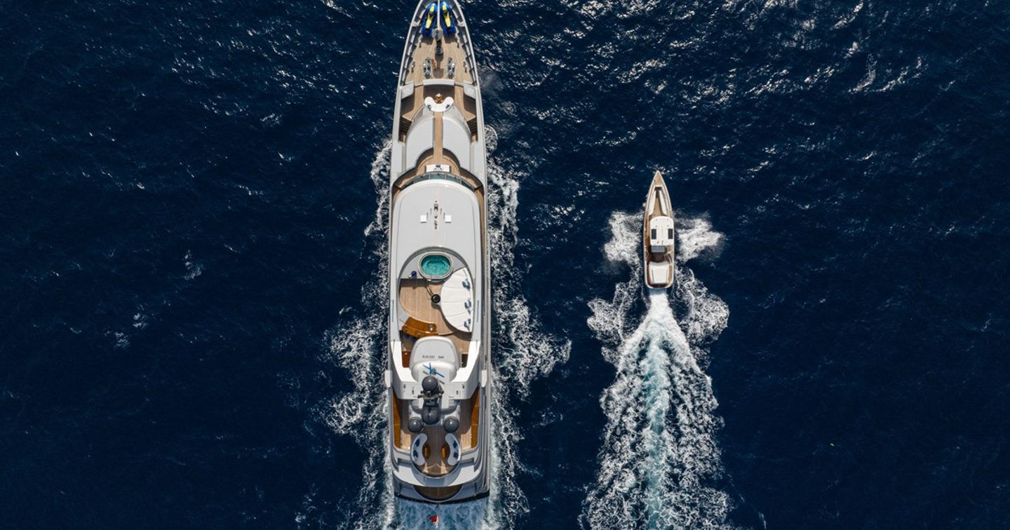 Aerial view of motor yacht Vibrance underway alongside jetski