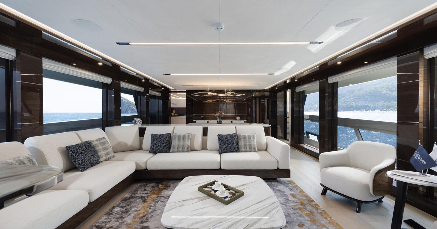 Lazzara UHV 100 Motor Yacht main salon with L-shaped white sofa