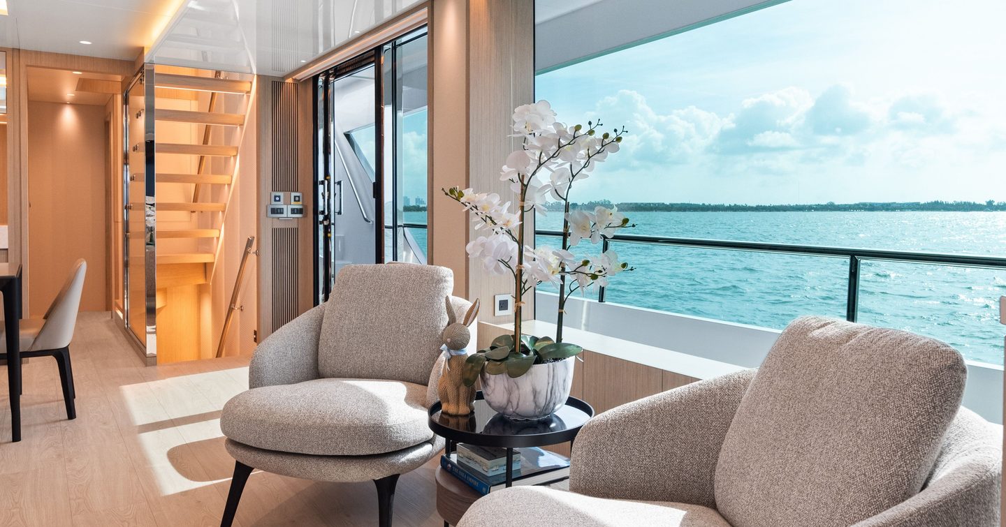 Superyacht No Regret II's main saloon chairs next to window