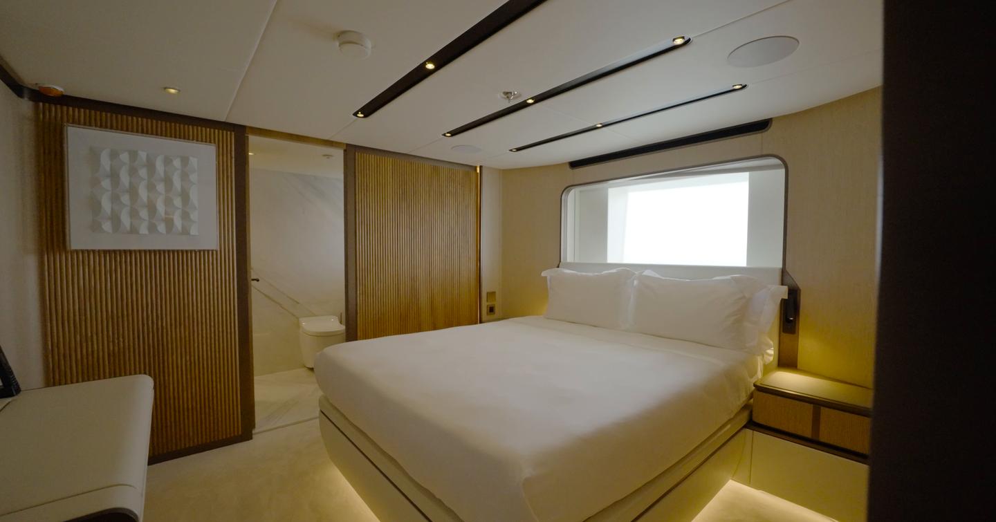 Forward guest double cabin aboard the Gulf Craft Majesty 145 with hull window and ensuite bathroom access