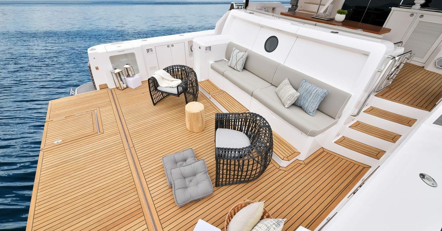 Motor yacht Ikigai stern with integrated seating and woven beach chairs