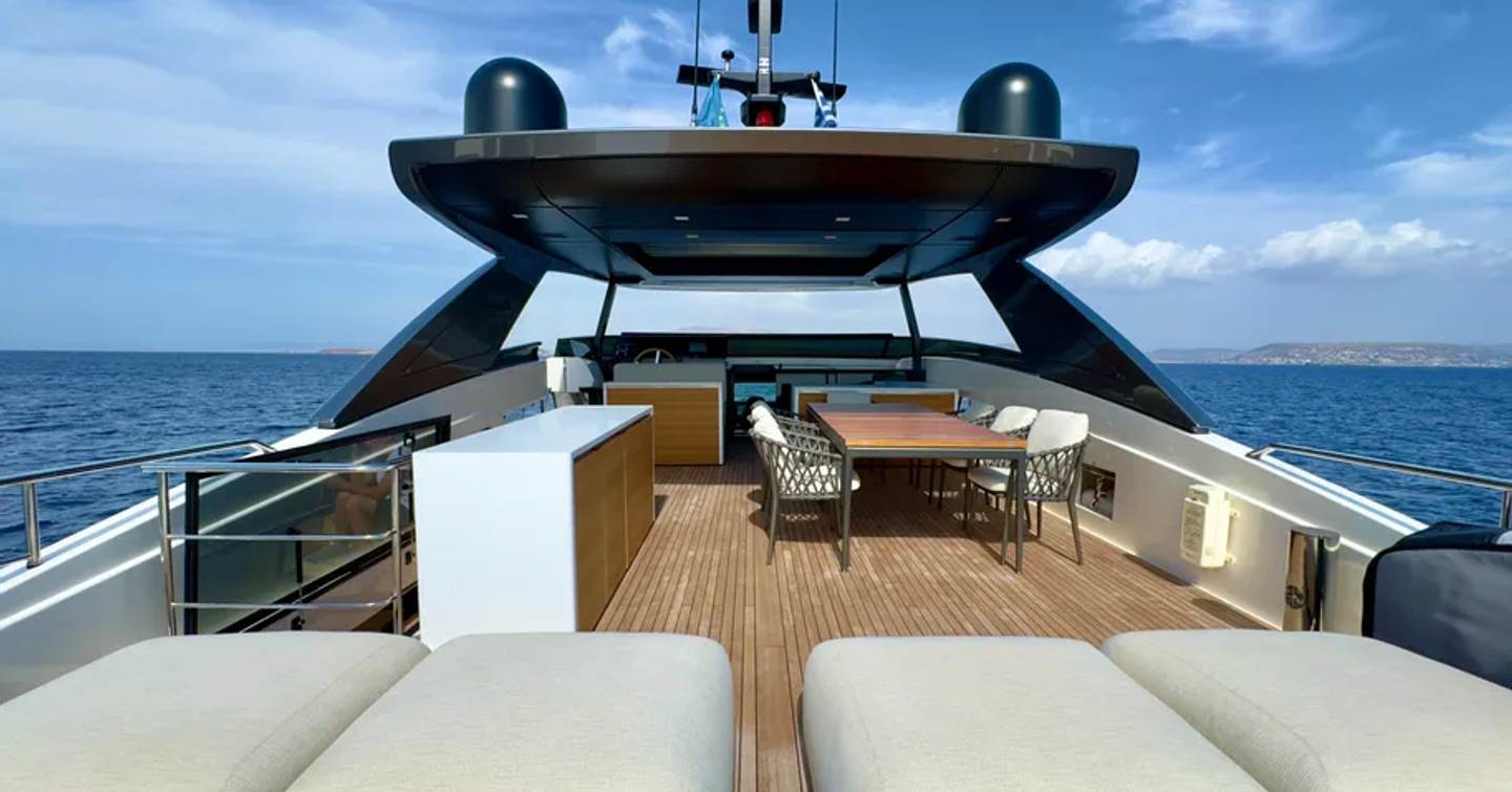 Motor yacht Judy's upper deck with sunpads and shaded seating
