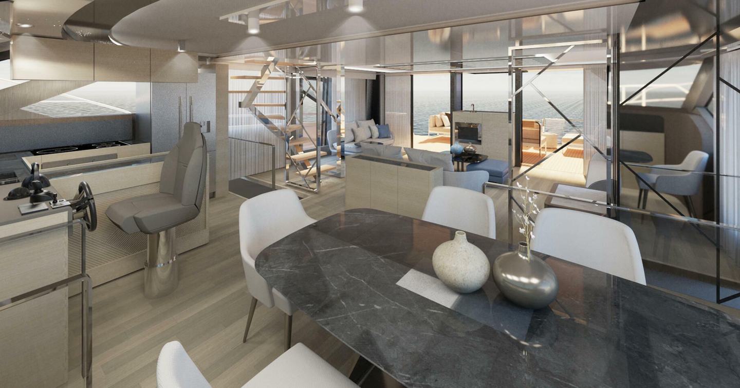 Overview of interior onboard Prestige M8, formal dining area in foreground with galley to starboard.