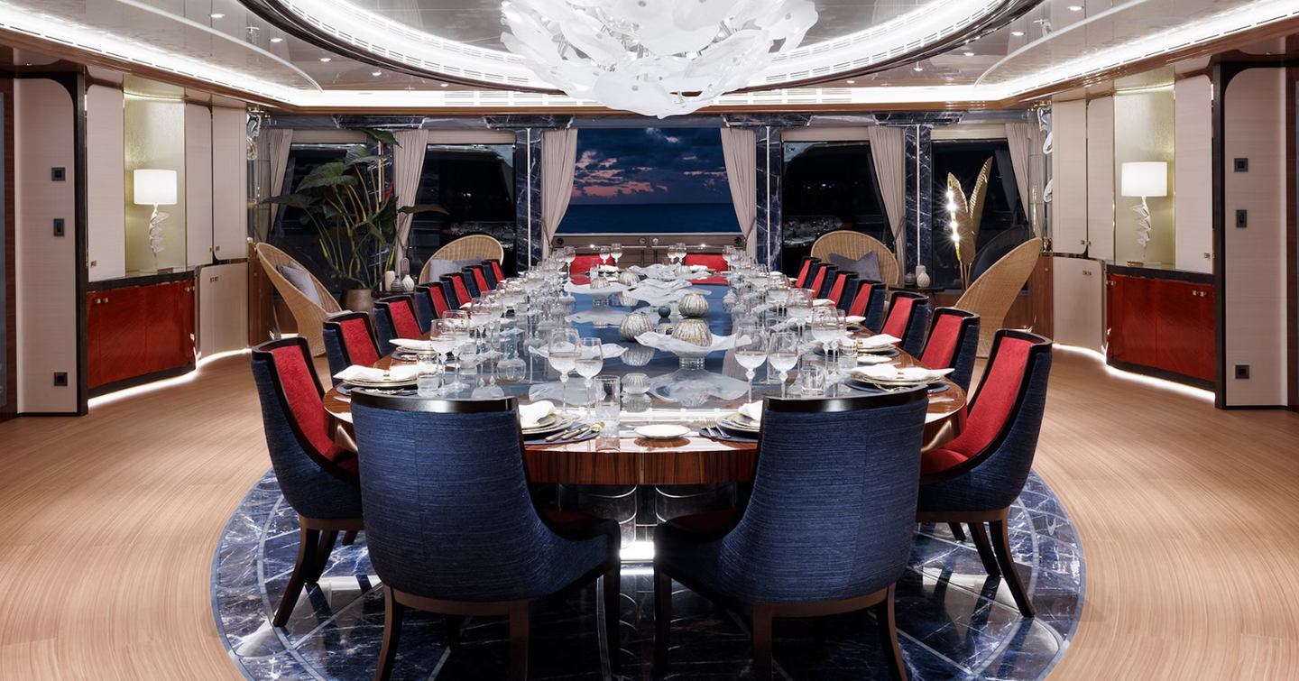 Superyacht Ahpo main interior dining area with red and black chairs