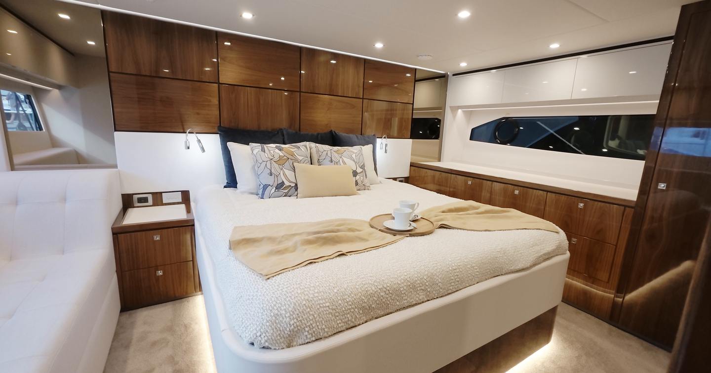 Riviera 5600 Sport Platinum Edition full-beam owner's cabin with gloss walnut joinery