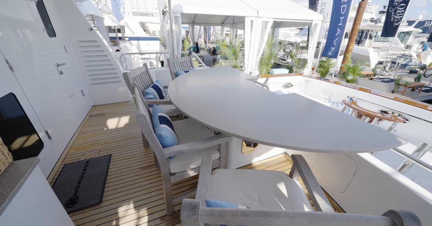 Nordhavn 75 EYF mezzanine deck with shaded outdoor dining overlooking the tournament fishing cockpit