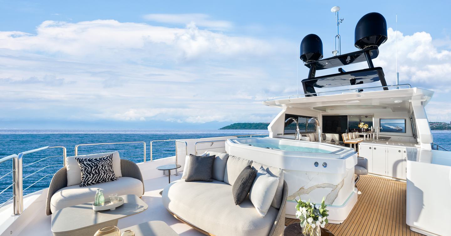 Horizon FD100 Skyline motor yacht upper aft deck with jacuzzi and plush grey seating