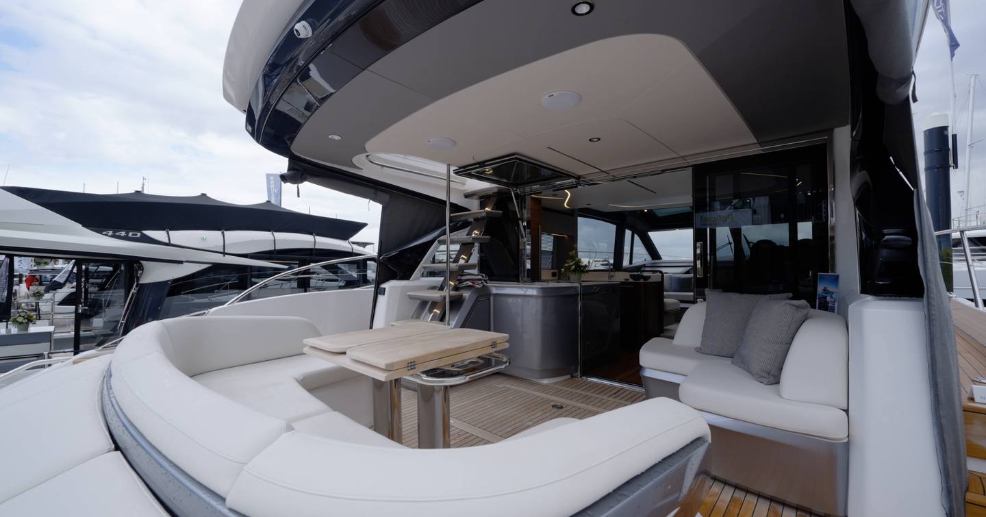Princess S65 Mk2 aft cockpit with wraparound seating, dining table and sportsbridge stairs