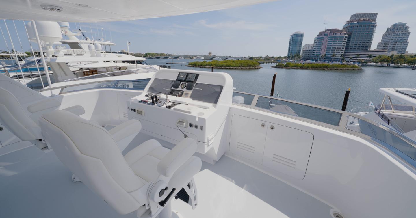 Nordhavn 75 EYF flybridge helm with twin captain's chairs and elevated navigation station