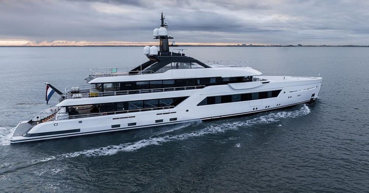 Amels 60 Project Witchcraft heading out to sea for sea trials. Thin stretch of land in far distance in background.