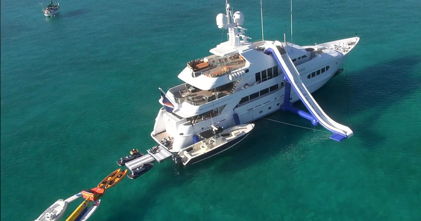 Superyacht Perle Bleue at anchor with tenders and inflatable slide