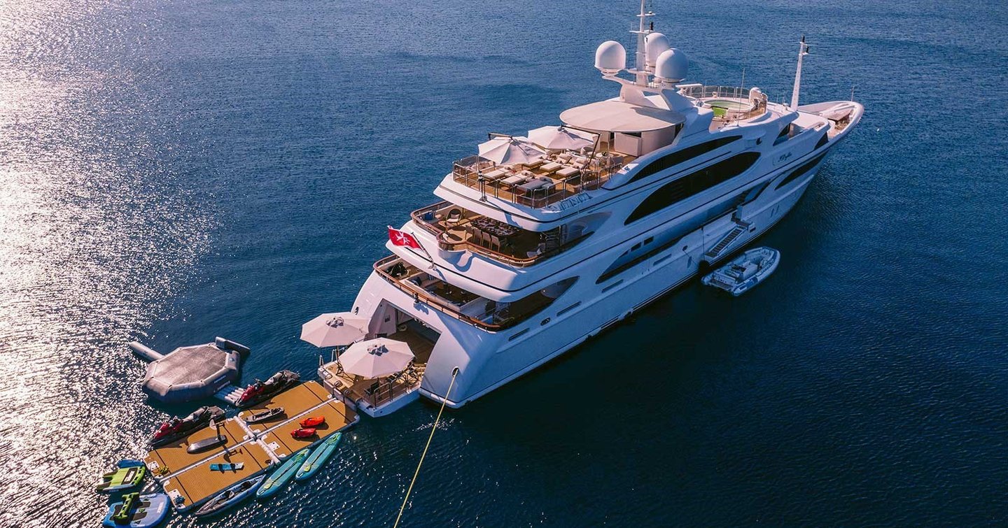 Superyacht IDyllic at anchor with extended beach club and tenders 