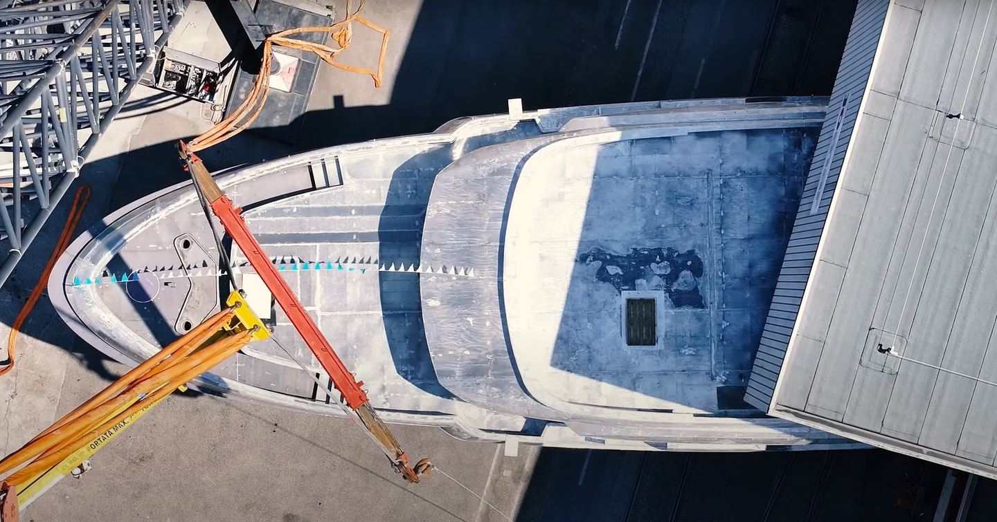 Aerial view of bow of Second CdM Deep Blue 141 Explorer Yacht leaving shipyard
