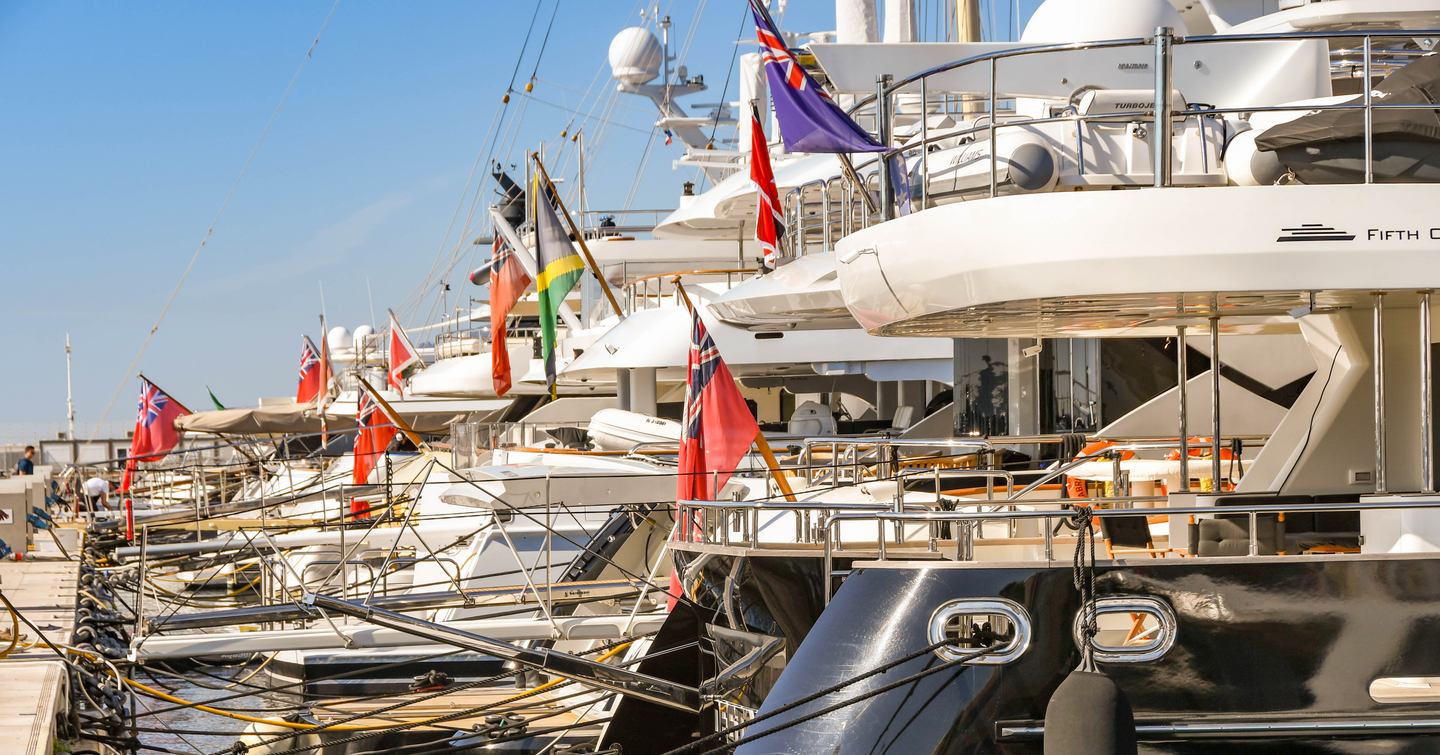 Yachts lined up with flags on them