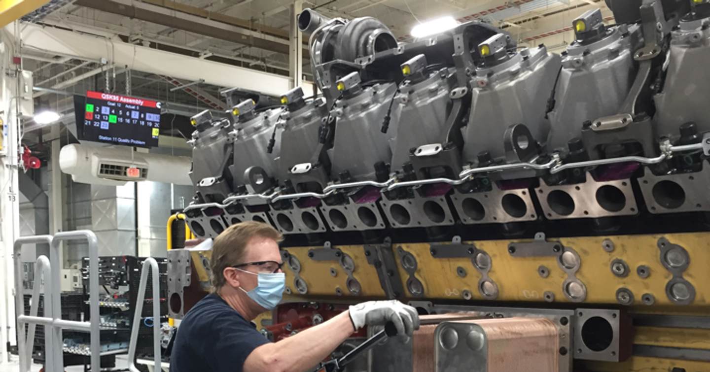 Cummins employee working on an engine.