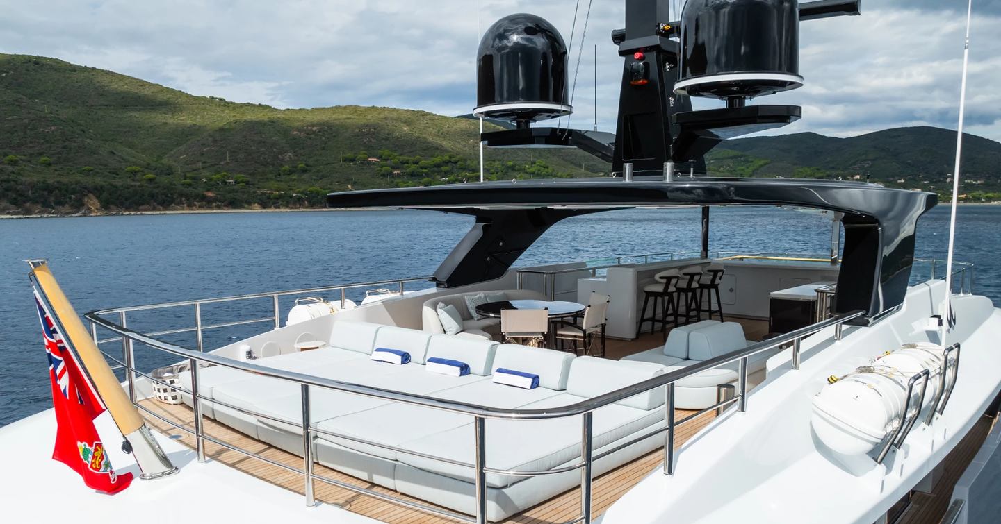 White sun-loungers and furniture on the sundeck of motor yacht M