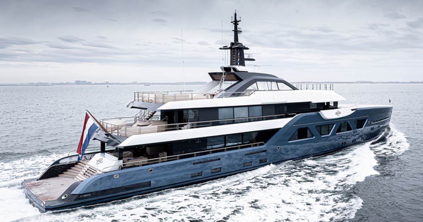 The Amels 60 superyacht 21.12 showing its starboard-side, running through a clam grey sea