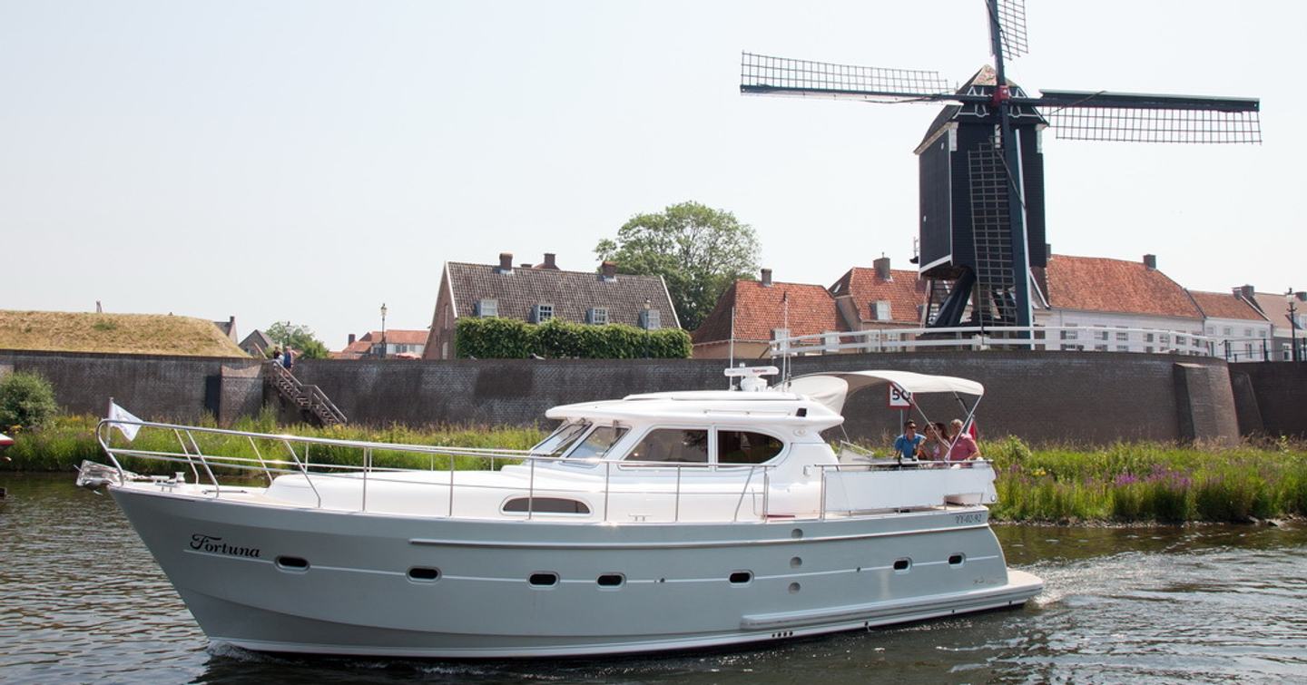 Elling E4 passagemaker yacht cruising past Dutch windmill