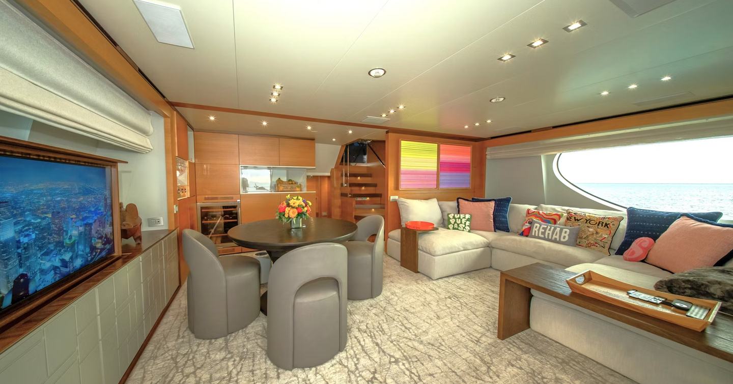 Motor Yacht Rehab's bright interior with circular dining table 