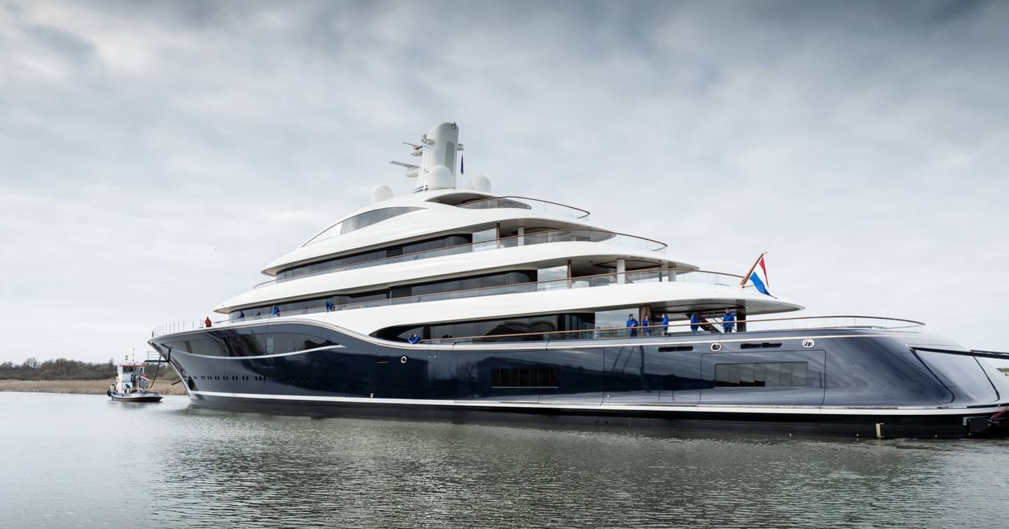 Feadship Superyacht Project 1014 following tugboat with stormy clouds 